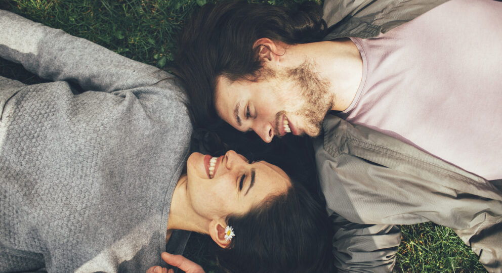 Turn towards. Image of couple looking at one another fondly.