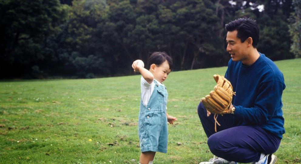 Image of father with toddler playing ball