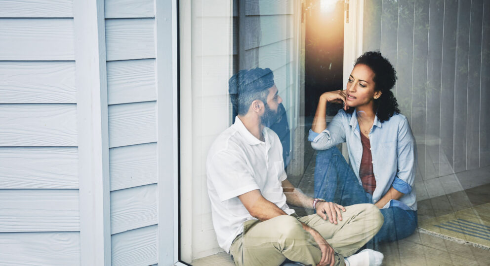 image of couple on their porch talking earnestly