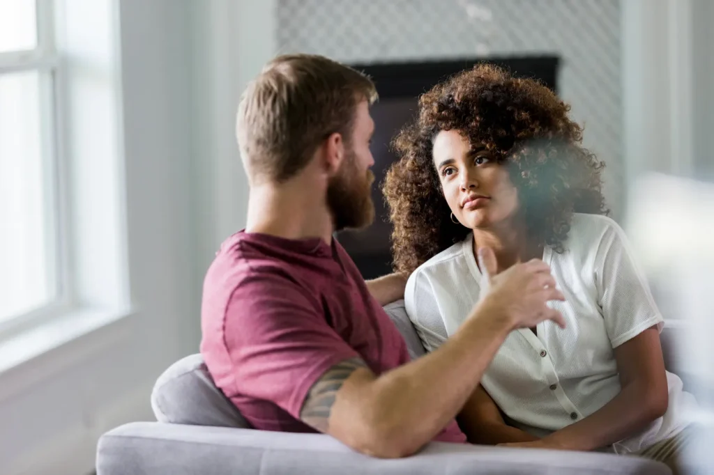 A young couple is having a serious conversation as they plan their future together.