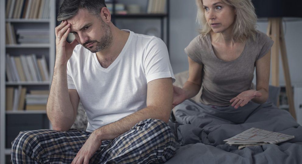 Married couple arguing in bedroom