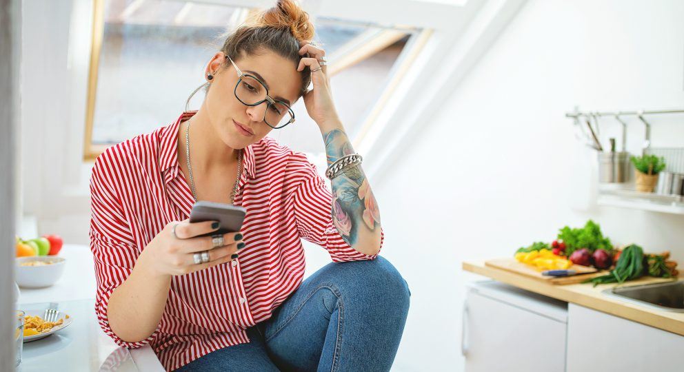 The truth about boundaries. Image of woman concentrating while looking at her phone.