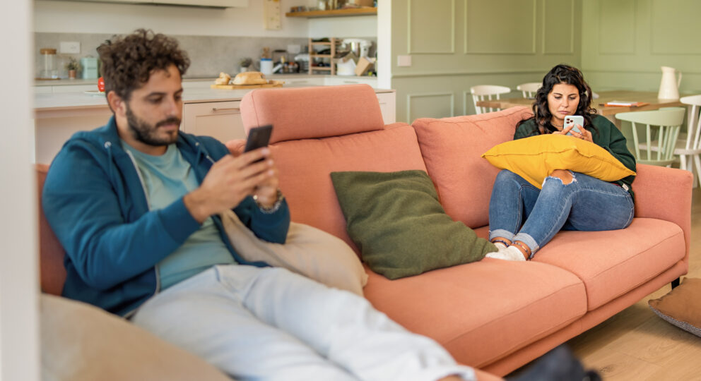 Couple turning toward screens and technology instead of each other