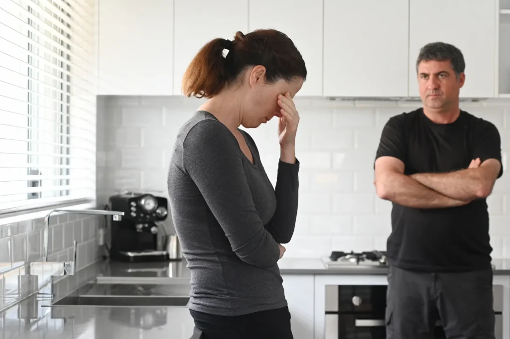 Couple in the kitchen distressed after another argument.