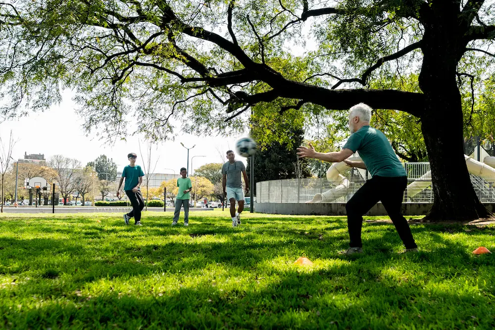 Kids playing in park with father figure mentoring.