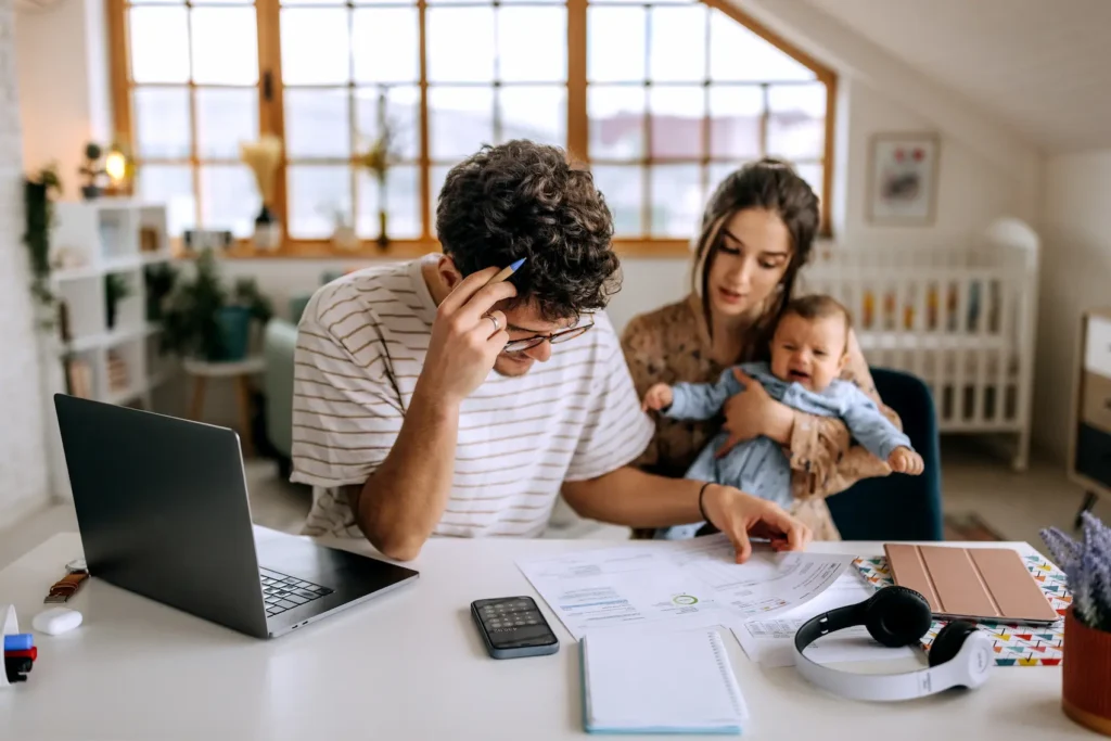 Young couple with a baby dealing with stressors of a becoming parents.