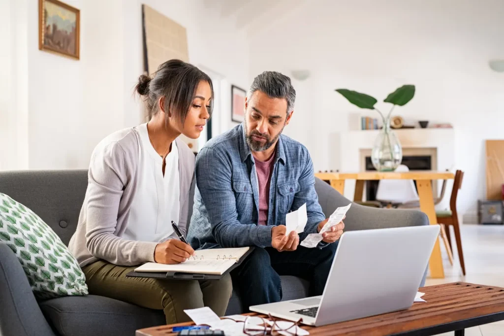 A couple working together on their finances with open communication and transparency.