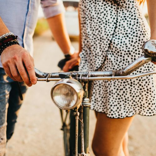 Couple with bicycle at rural road